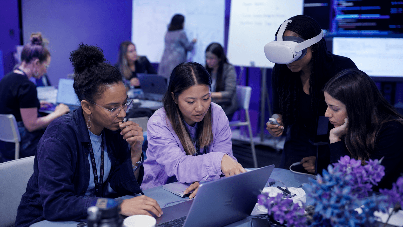 Builders working on WebXR experiences with VR headsets at a DIALED IN workshop
